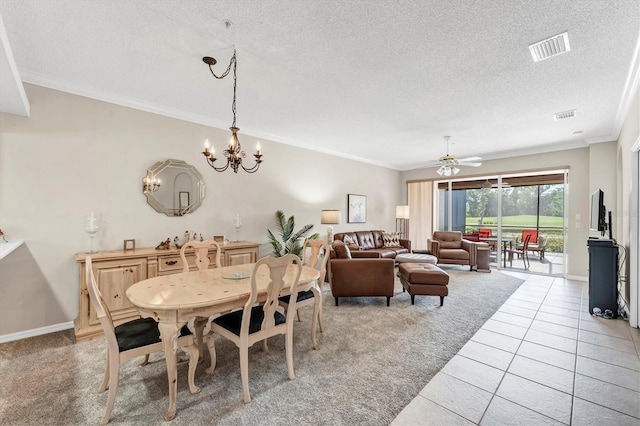 dining space with crown molding, light carpet, a textured ceiling, and visible vents