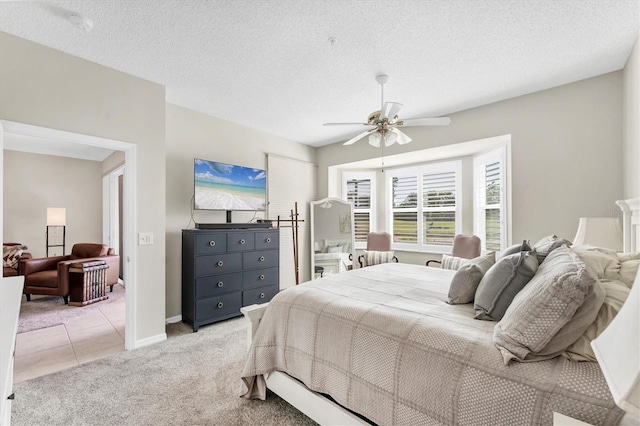 bedroom with baseboards, a ceiling fan, and light carpet