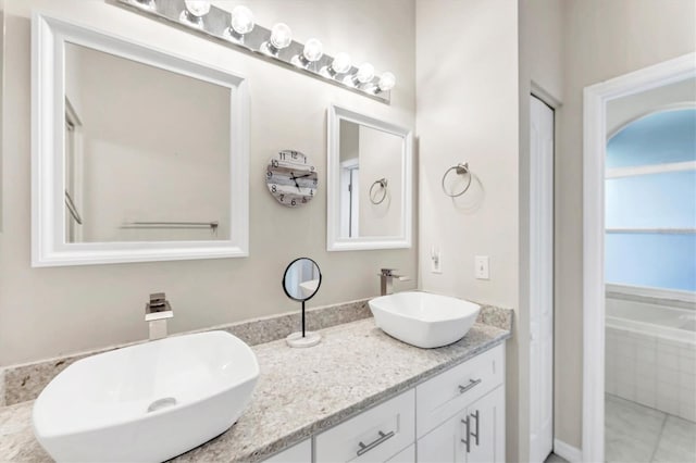 full bath with a sink and double vanity