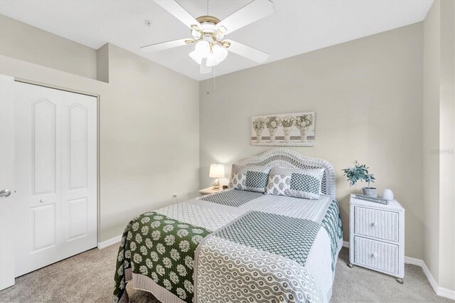 carpeted bedroom featuring baseboards and a ceiling fan