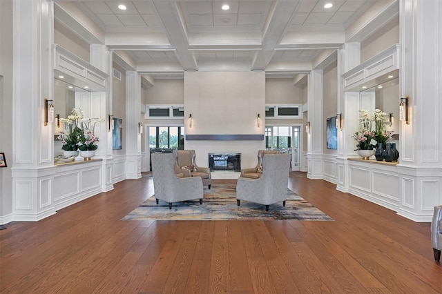 living room featuring recessed lighting, a healthy amount of sunlight, and coffered ceiling