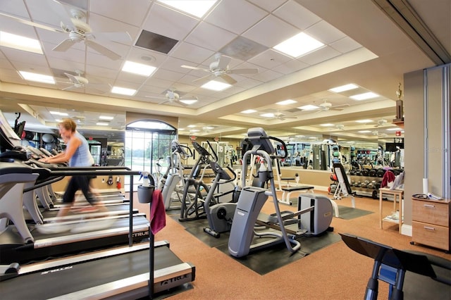 gym featuring ceiling fan and a drop ceiling