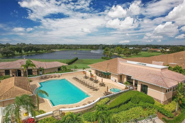 community pool with fence private yard, a water view, and a patio area
