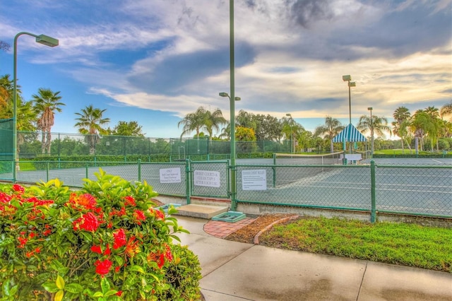 view of sport court featuring fence