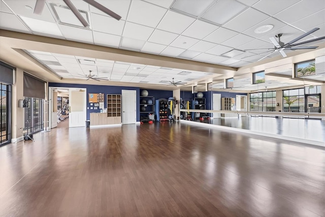 5217 Chase Oaks Dr, Sarasota, FL 34241 - workout room featuring ceiling fan, a paneled ceiling, wood finished floors, and baseboards