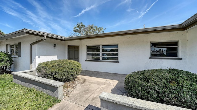 2702 Bedford Way, Sarasota, FL 34239 - property entrance with a patio and stucco siding