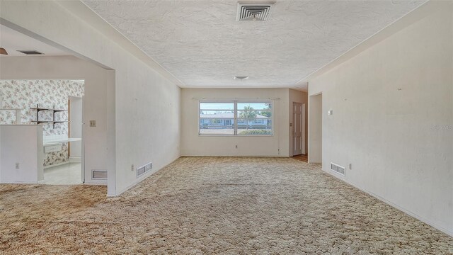 2702 Bedford Way, Sarasota, FL 34239 - carpeted spare room with visible vents and a textured ceiling