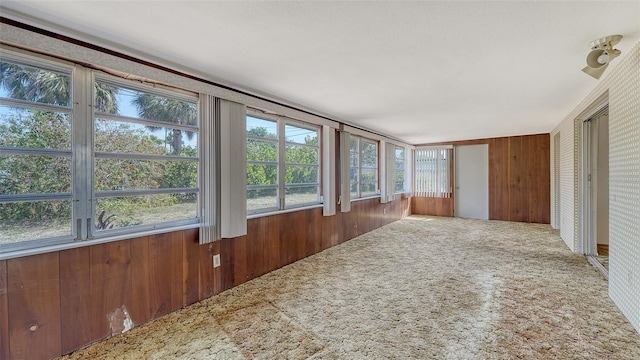 2702 Bedford Way, Sarasota, FL 34239 - unfurnished sunroom featuring carpet floors and wood walls