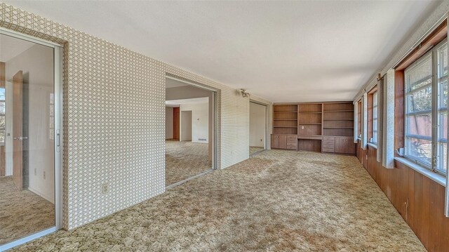 2702 Bedford Way, Sarasota, FL 34239 - interior space with carpet flooring, wallpapered walls, and built in shelves