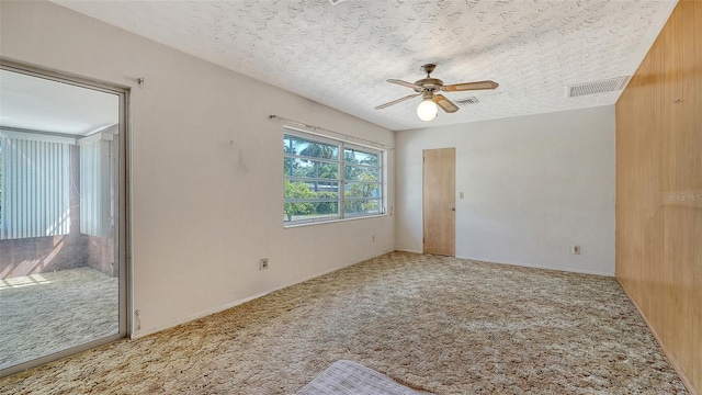 2702 Bedford Way, Sarasota, FL 34239 - carpeted spare room featuring ceiling fan, a textured ceiling, and visible vents
