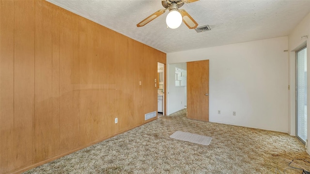 2702 Bedford Way, Sarasota, FL 34239 - spare room with carpet floors, a ceiling fan, a textured ceiling, and visible vents