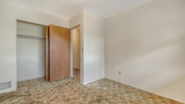 2702 Bedford Way, Sarasota, FL 34239 - unfurnished bedroom featuring carpet floors, baseboards, visible vents, and a closet