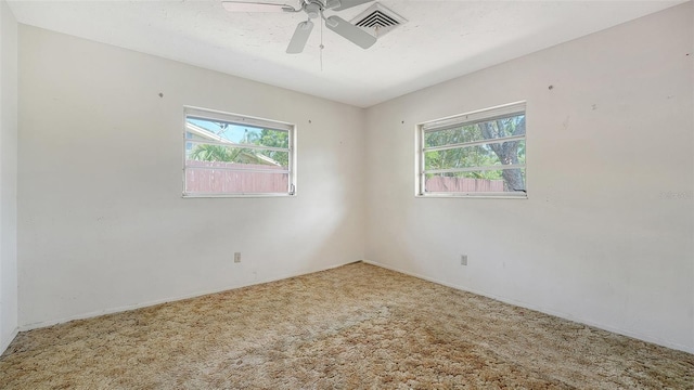 2702 Bedford Way, Sarasota, FL 34239 - unfurnished room with visible vents, carpet flooring, ceiling fan, and a healthy amount of sunlight