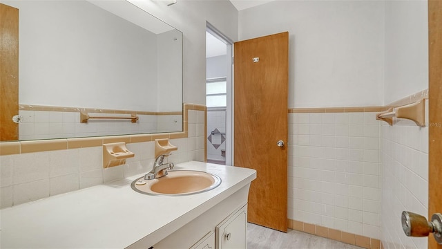 2702 Bedford Way, Sarasota, FL 34239 - bathroom with tile walls, wainscoting, wood finished floors, and vanity