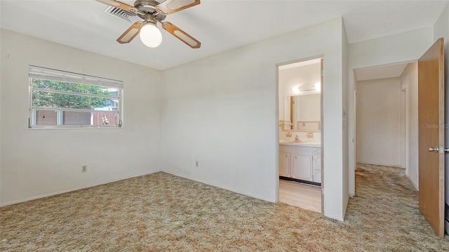 2702 Bedford Way, Sarasota, FL 34239 - unfurnished bedroom featuring carpet flooring, ceiling fan, and ensuite bath