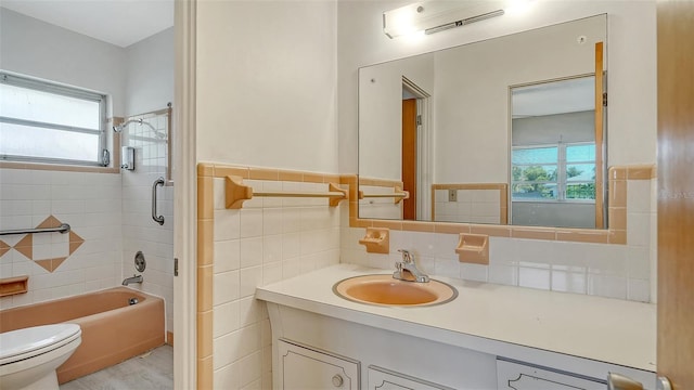 2702 Bedford Way, Sarasota, FL 34239 - bathroom featuring vanity, wainscoting, shower / bathtub combination, toilet, and tile walls