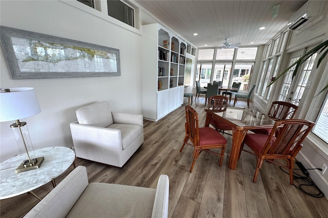 sunroom / solarium featuring healthy amount of natural light and a wall unit AC