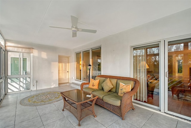 living area featuring plenty of natural light, ceiling fan, and tile patterned floors