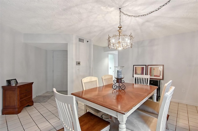 dining area featuring light tile patterned flooring, a chandelier, and baseboards