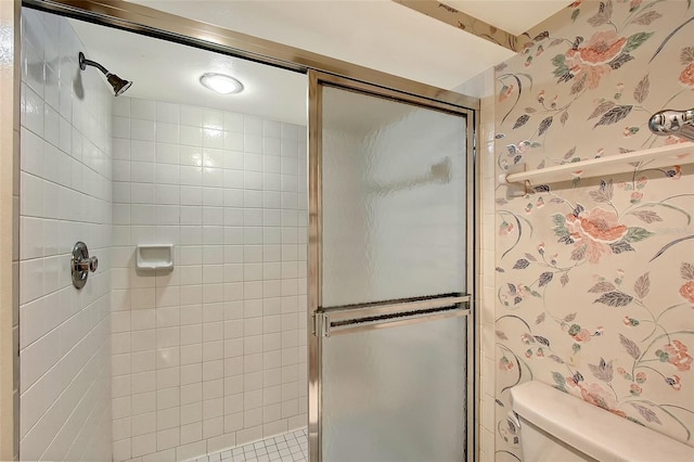 full bath featuring wallpapered walls, a shower stall, and toilet