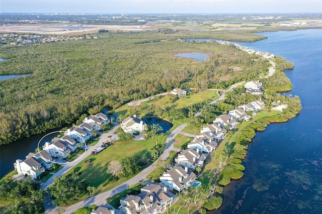 aerial view of property and surrounding area featuring a large body of water and nearby suburban area