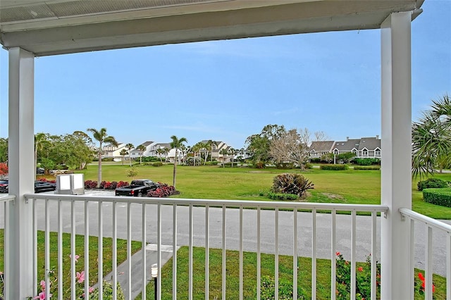 view of yard with a residential view and a balcony