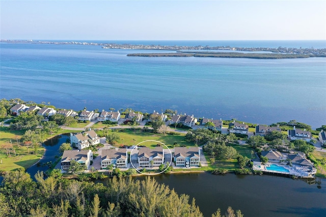 aerial overview of property's location with a nearby body of water and nearby suburban area