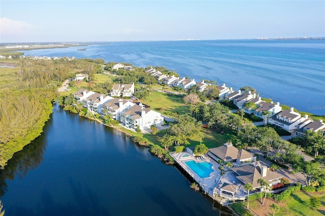 aerial view of property's location with a large body of water and nearby suburban area