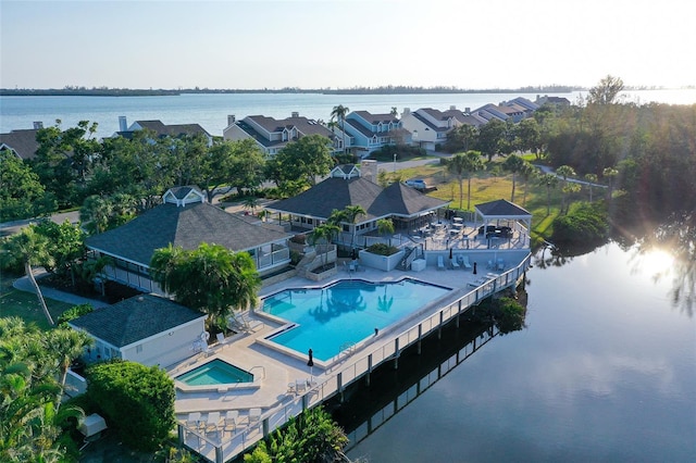 aerial view of a pool and a nearby body of water