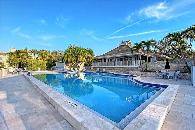 community pool featuring a patio area and fence