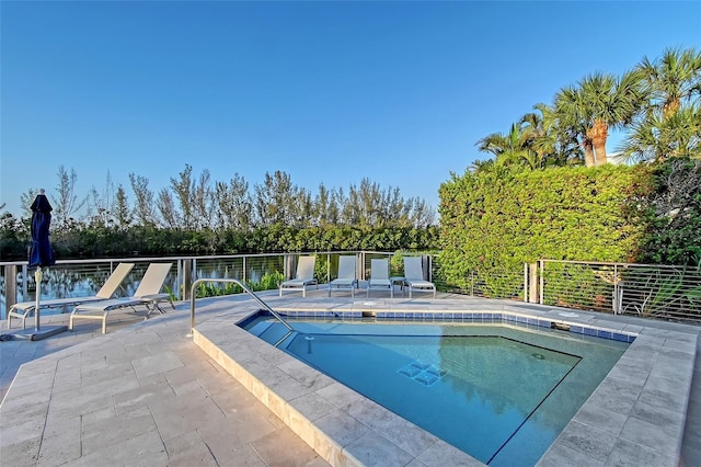 view of swimming pool featuring a pool, a patio area, and fence