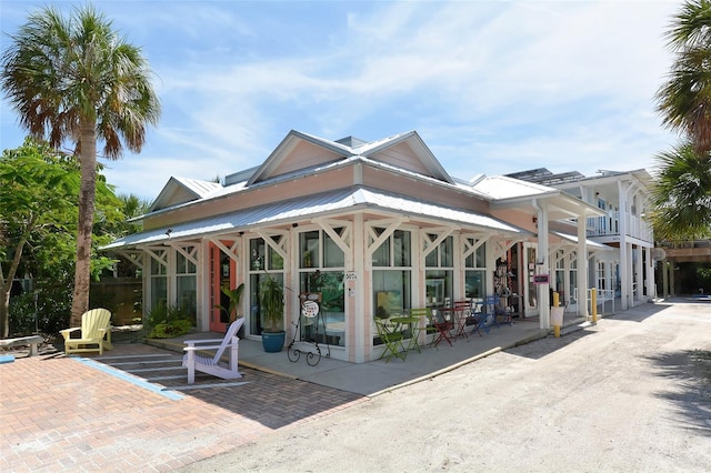 back of property featuring metal roof