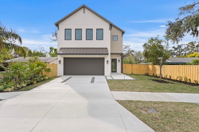 2554 Arlington St, Sarasota, FL 34239 - contemporary home with a standing seam roof, fence, concrete driveway, an attached garage, and stucco siding