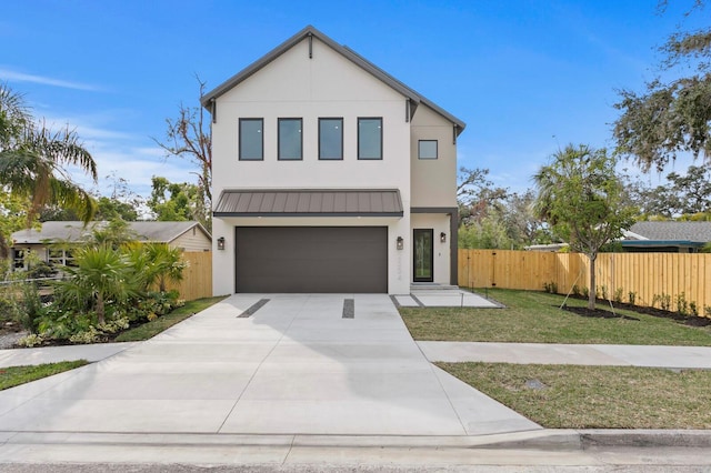 2554 Arlington St, Sarasota, FL 34239 - modern home with fence, stucco siding, a standing seam roof, concrete driveway, and an attached garage