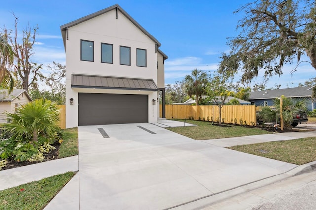2554 Arlington St, Sarasota, FL 34239 - contemporary home with fence, an attached garage, stucco siding, a standing seam roof, and driveway