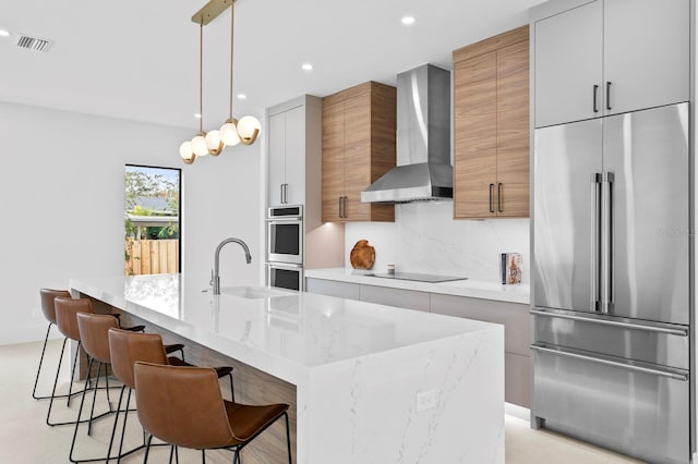 2554 Arlington St, Sarasota, FL 34239 - kitchen featuring appliances with stainless steel finishes, a sink, wall chimney exhaust hood, recessed lighting, and modern cabinets