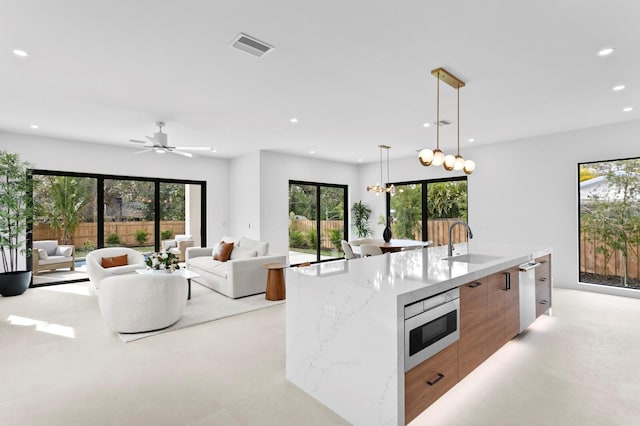 2554 Arlington St, Sarasota, FL 34239 - kitchen with modern cabinets, a spacious island, a sink, stainless steel appliances, and recessed lighting