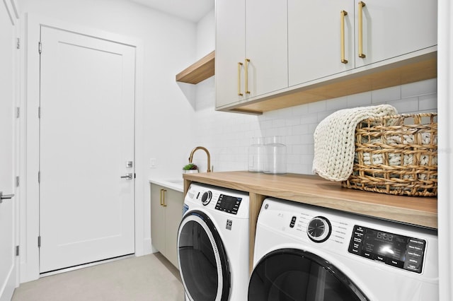 2554 Arlington St, Sarasota, FL 34239 - washroom featuring a sink, independent washer and dryer, and cabinet space