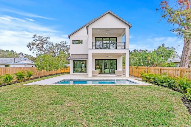 2554 Arlington St, Sarasota, FL 34239 - back of property with a balcony, a fenced backyard, an outdoor hangout area, a ceiling fan, and a lawn