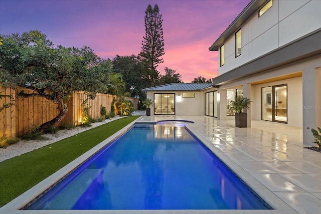 1559 Bay Rd, Sarasota, FL 34239 - pool at dusk with a patio, an in ground hot tub, a fenced in pool, and a fenced backyard