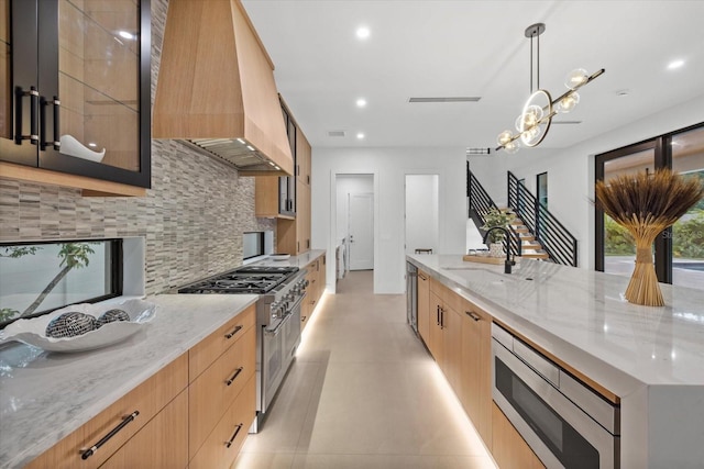 1559 Bay Rd, Sarasota, FL 34239 - kitchen featuring modern cabinets, tasteful backsplash, a sink, custom exhaust hood, and stainless steel appliances