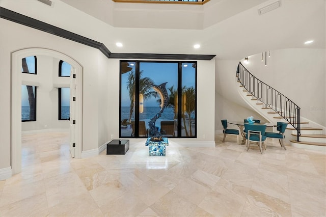 entryway featuring baseboards, marble finish floor, visible vents, arched walkways, and stairway