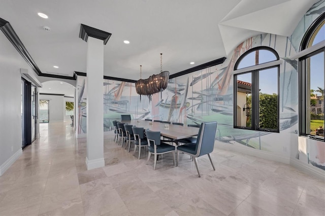 dining space with crown molding, arched walkways, baseboards, and decorative columns