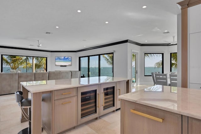 interior space with wine cooler, a healthy amount of sunlight, and visible vents