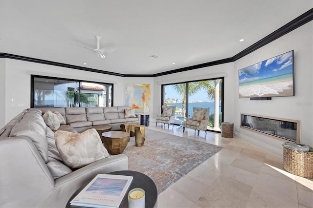 living room with crown molding, plenty of natural light, baseboards, and a ceiling fan