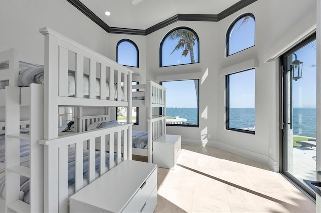 unfurnished bedroom with ornamental molding, baseboards, tile patterned flooring, a water view, and access to outside