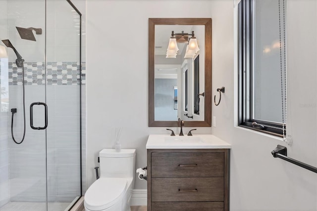 bathroom with vanity, toilet, and a shower stall