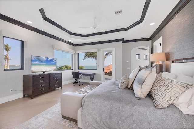 bedroom with a tray ceiling, visible vents, access to exterior, and ornamental molding