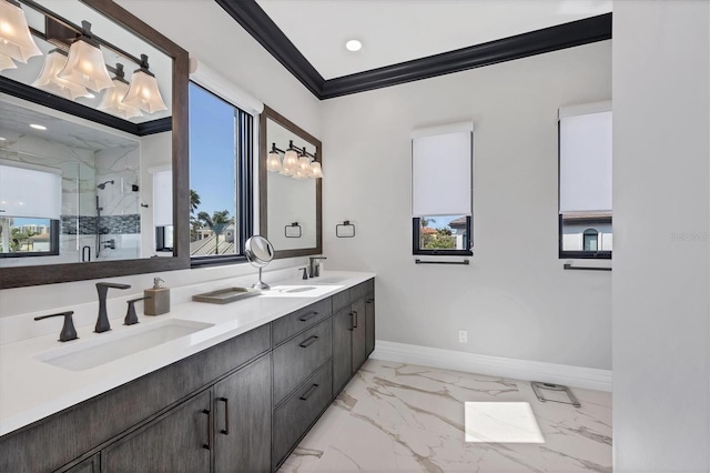 bathroom with baseboards, ornamental molding, a sink, and a marble finish shower