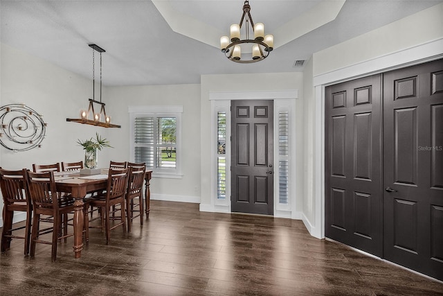 dining area featuring baseboards, a notable chandelier, visible vents, and dark wood-type flooring